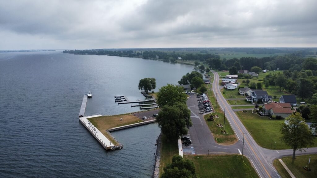 Aerial view of the boat ramp, docks, breakwater, and parking area at Cape Vincent Public Boat Launch