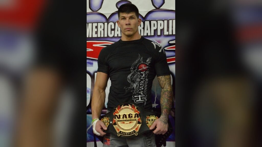 Dustin Baker holding the NAGA championship belt, Boston 2016