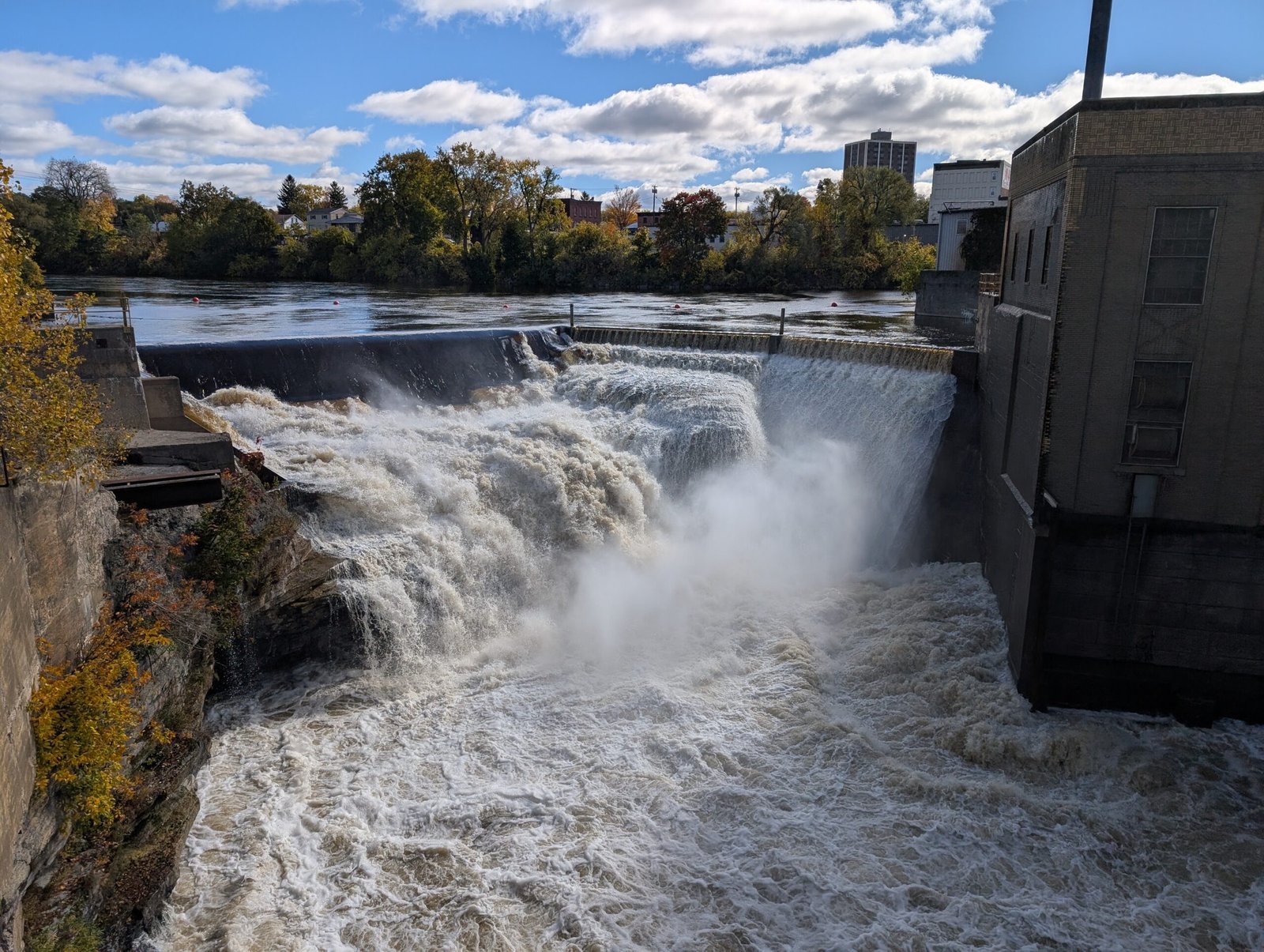 Great Falls on the Black River in Watertown, water pouring over the dam in high flow, with the hydro building at right