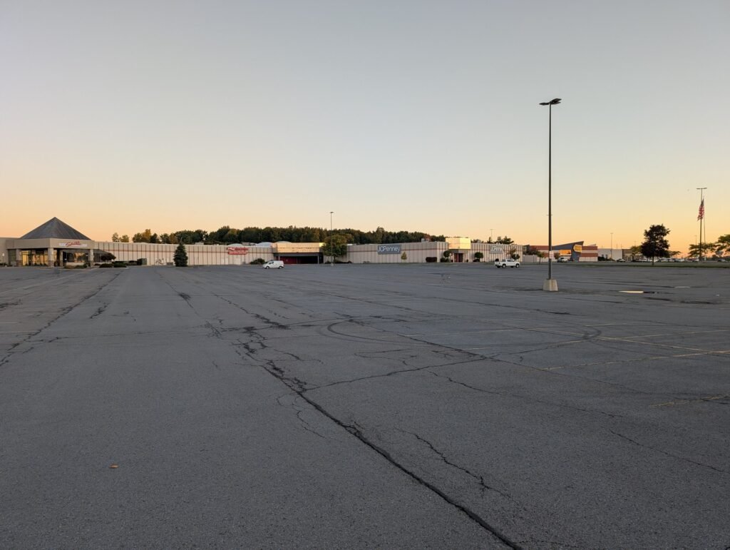 Salmon Run Mall exterior in Watertown NY at sunrise with JCPenney and Regal signage